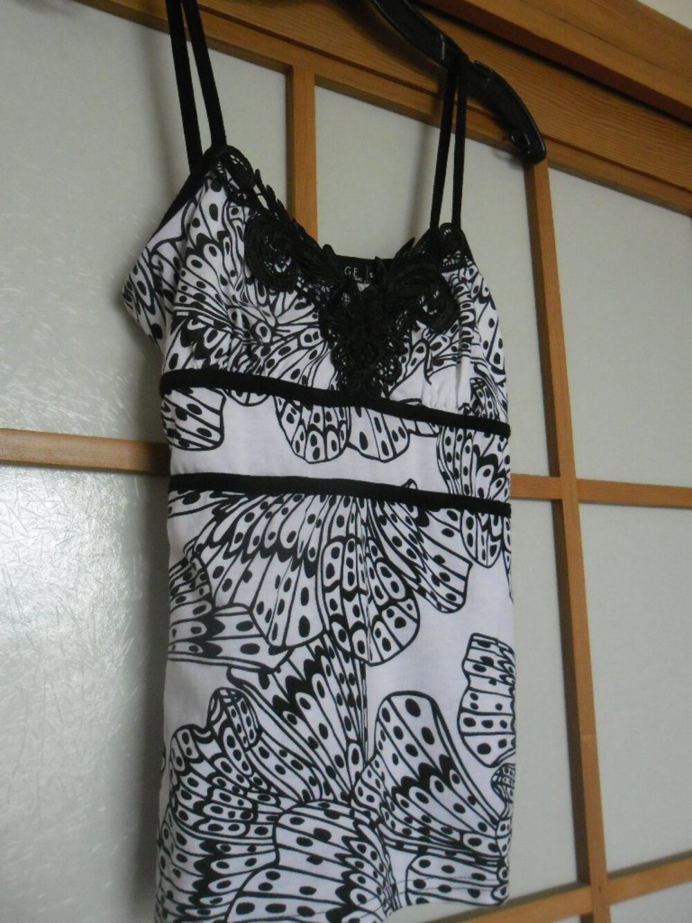 George butterfly print top with elegant lace and sequin detail at the neckline.